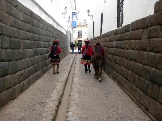 Schoolgirls walking through Cusco with their llama.