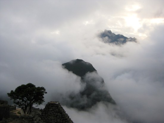 Andes mountaintops surrounded by early fog.